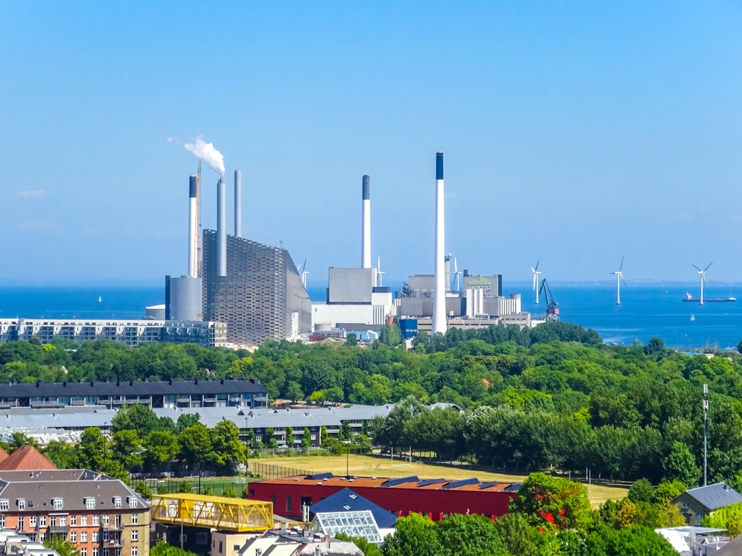 industrial-power-plant-with-smokestacks-by-the-ocean-qqdsstfis14